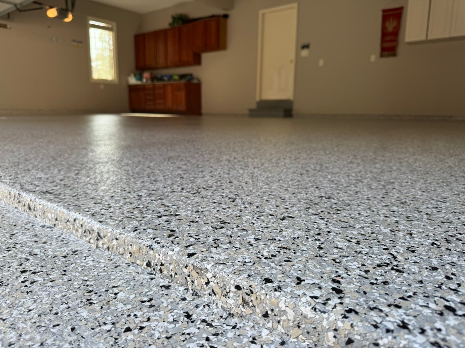 Basement floor coated with polyaspartic flake system in Lancaster PA home