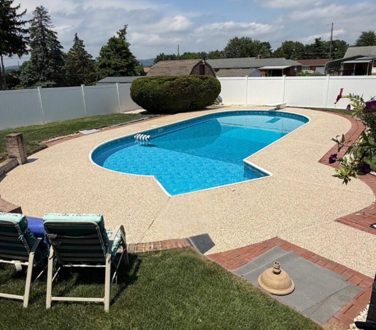 Slip-resistant polyaspartic pool deck coating with decorative flakes installed by FlakePro Coatings in Pennsylvania.