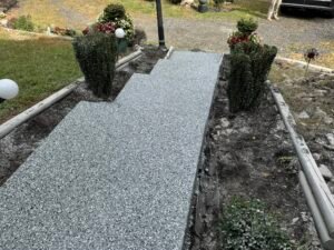 Homeowner mopping a polyaspartic garage floor with pH-neutral cleaner