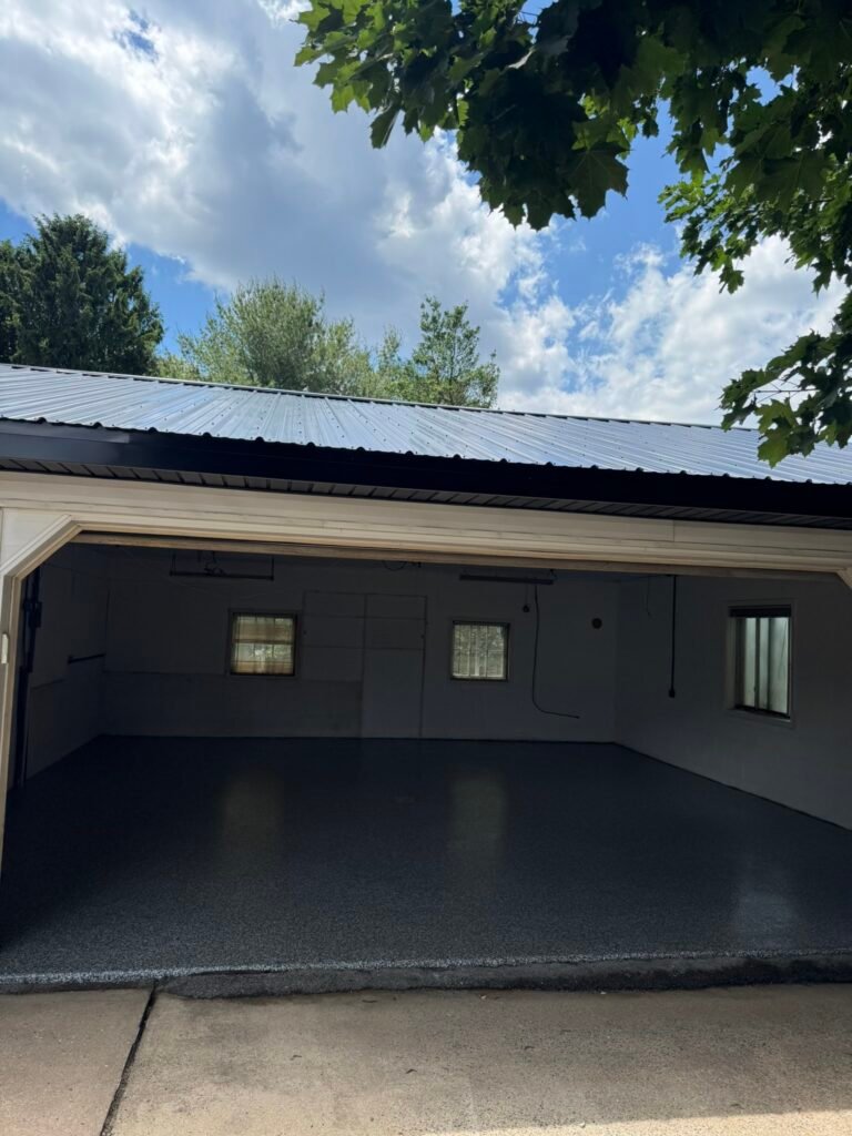 Charcoal and white flake polyaspartic garage floor coating after installation