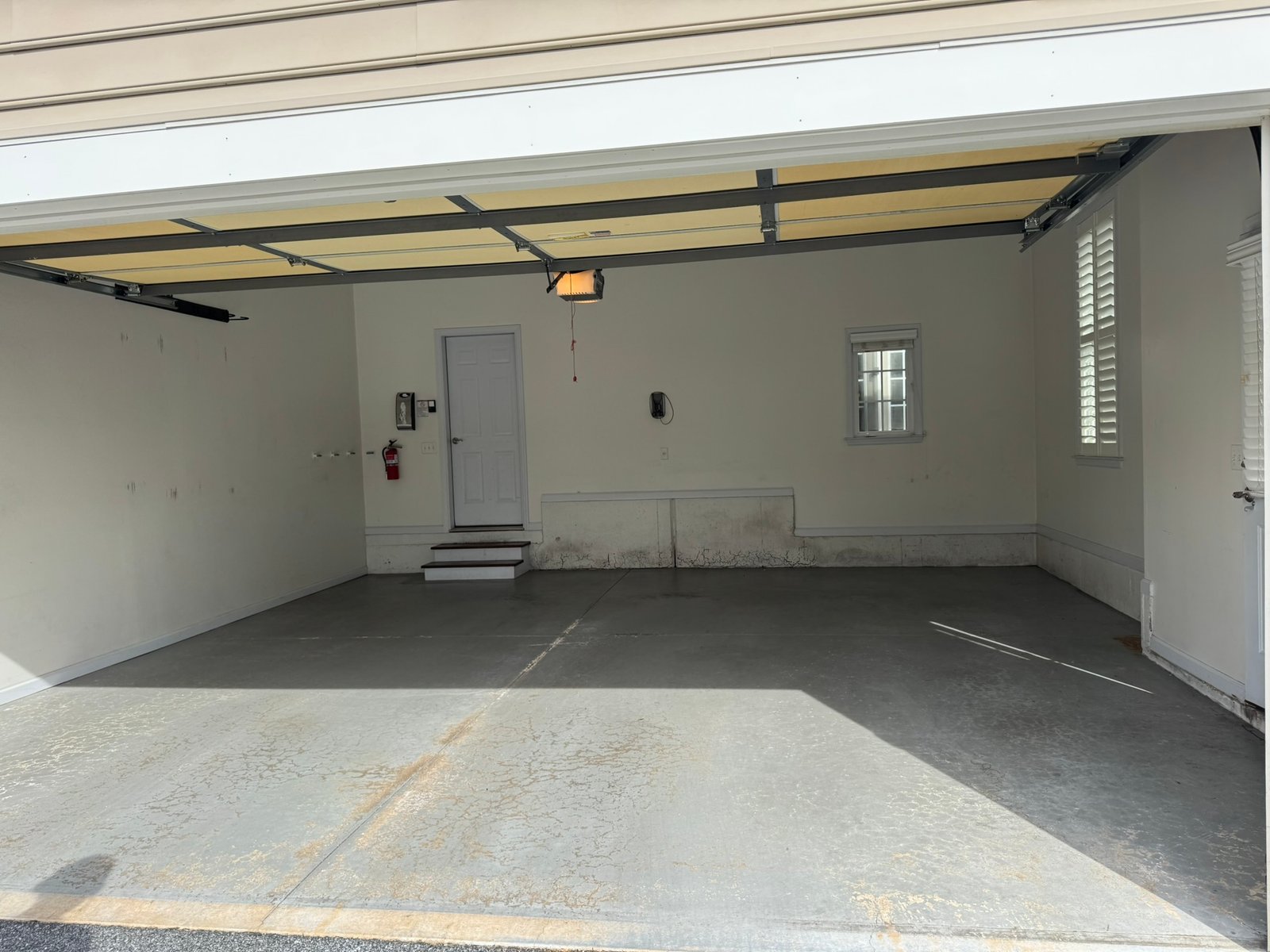 Gray, black and white flake pole-barn floor coating, crew and branded van at open door
