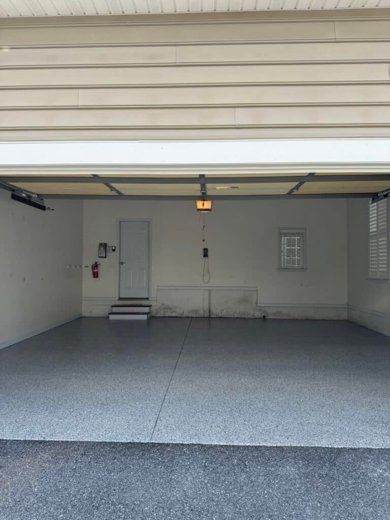 Low-angle view of blue, gray and white flake garage floor coating