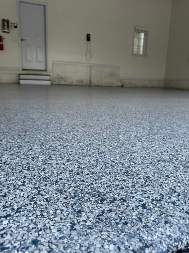 Close-up texture of blue, gray and white flake garage floor coating