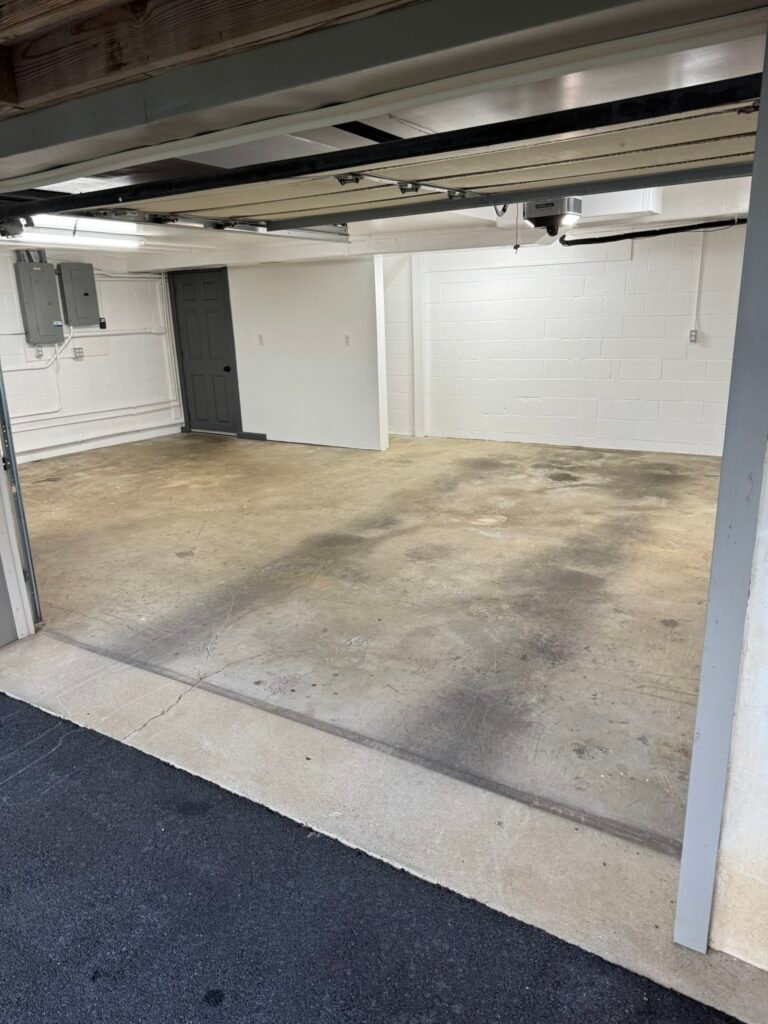 Stained bare concrete garage floor before polyaspartic coating
