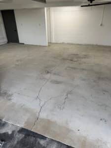Close-up of cracked concrete garage floor before crack repair and coating