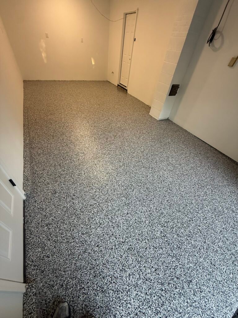 Gray, black and white flake floor coating in finished garage