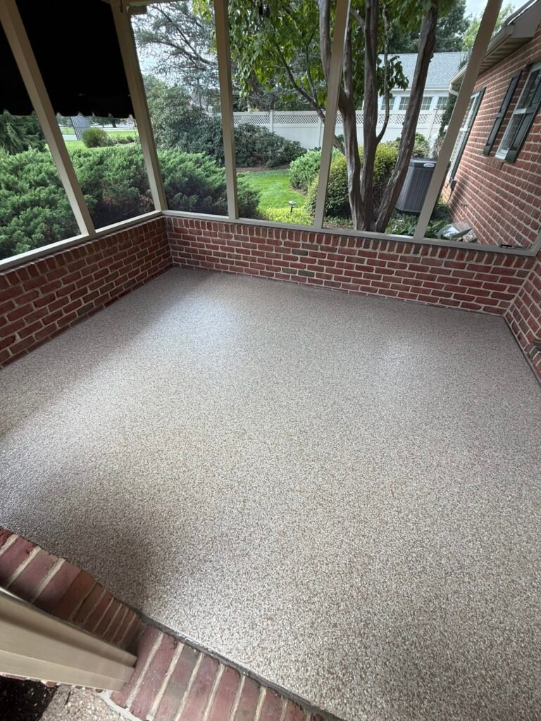 Tan, beige, black and white flake screened porch floor coating with brick knee walls